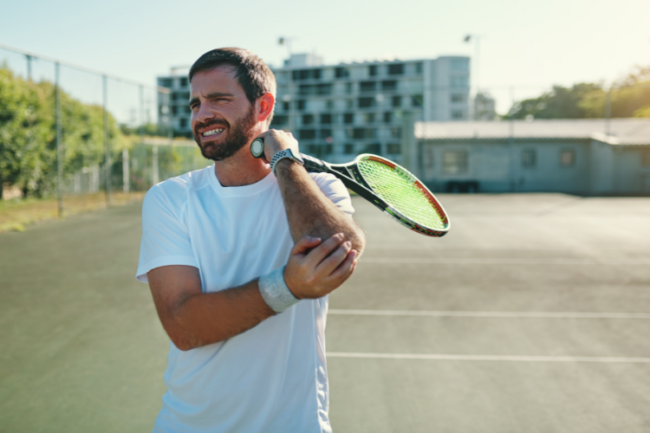 Tennis Elbow Symptoms Tennis player holding elbow in pain