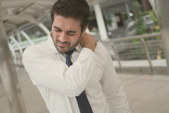 Shoulder Osteoarthritis Treatment Options Man holding shoulder in pain