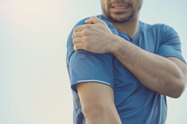 Man holding shoulder in pain