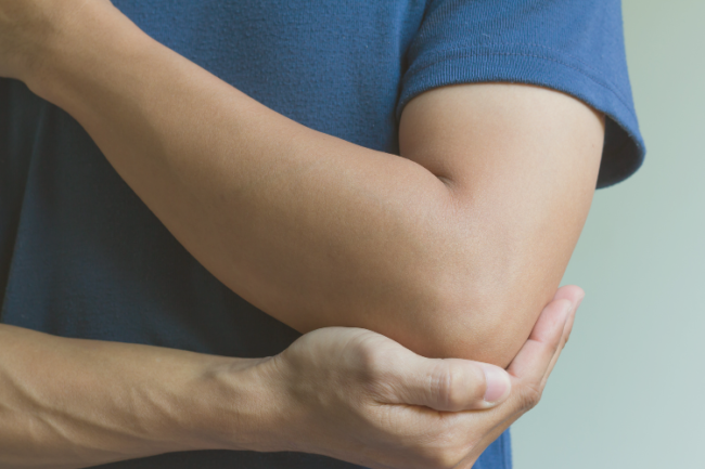 Humeral Shaft Fractures Man holding elbow