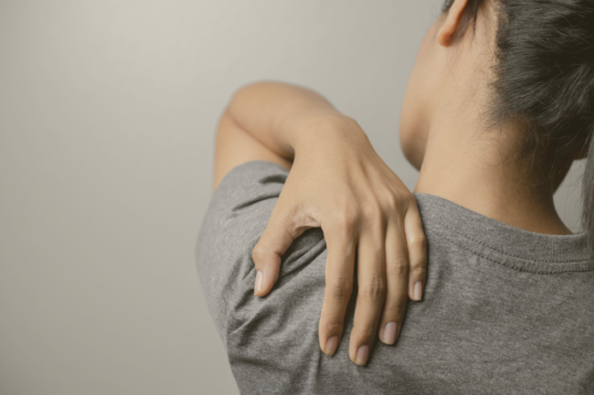 Long Term Shoulder Conditions Importance Diagnosis Treatment Back of person holding shoulder in pain