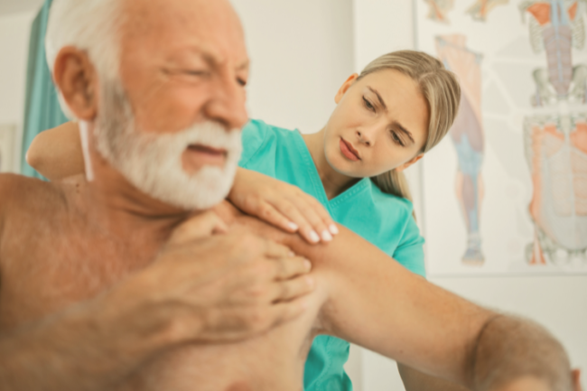 Double Shoulder Replacement Surgery Older man with physiotherapist and painful shoulder