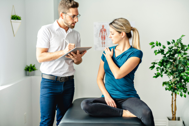Manual Therapy versus Exercise-based Physiotherapy Physiotherapist with patient holding shoulder