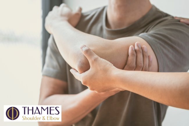 Radial Head Fractures Causes Diagnosis and Treatment Man holding elbow and being assisted by medical professional