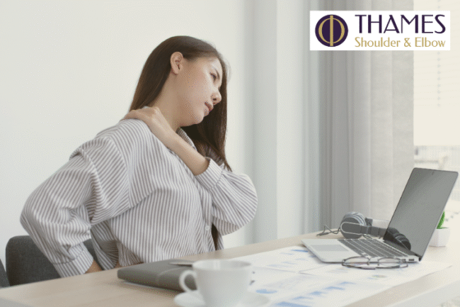 Shoulder Pain Affecting Quality of Life Woman at desk holding shoulder in pain